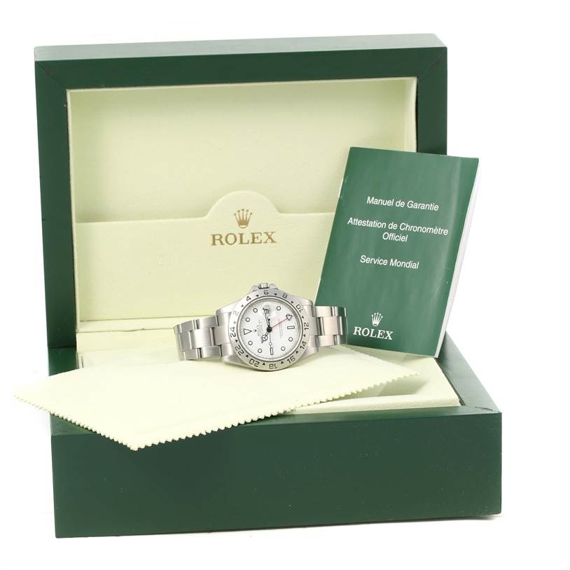 The image shows a Rolex Explorer 16570 Men's Stainless Steel White Dial 16570 Men's Stainless Steel White Dial watch, viewed from the front, inside its box with warranty manual and polishing cloth.