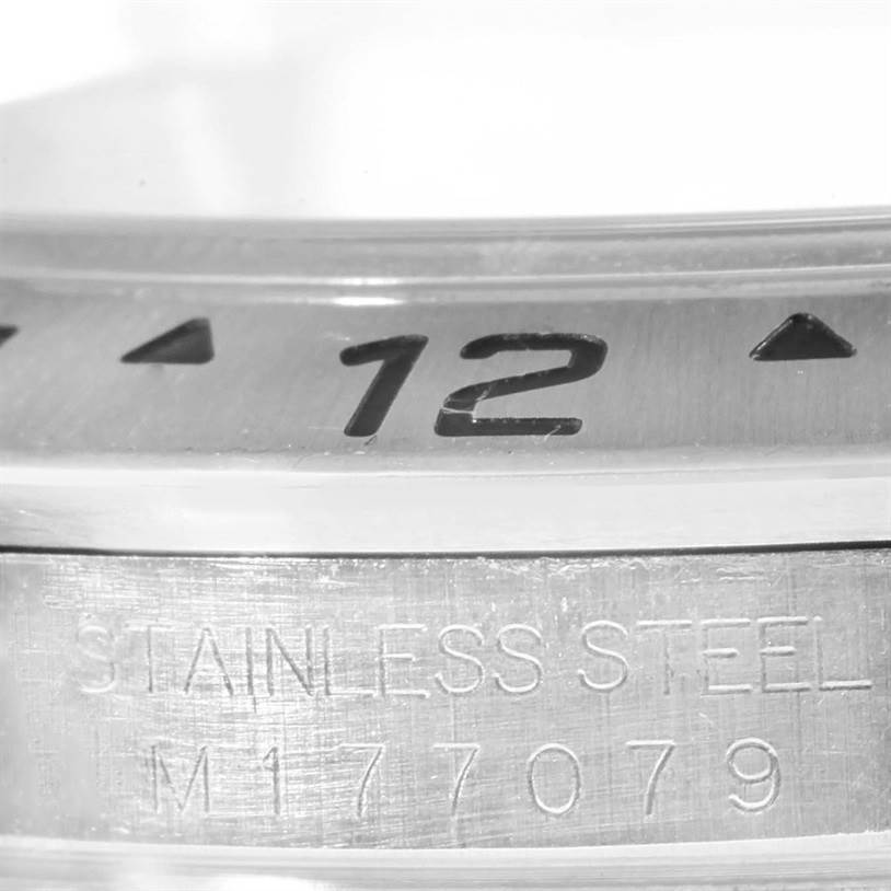 This image shows a close-up of the bezel and inner case of a Rolex Explorer 16570 Men's Stainless Steel White Dial 16570 Men's Stainless Steel White Dial watch, highlighting the "12" marker and "Stainless Steel" engraving.