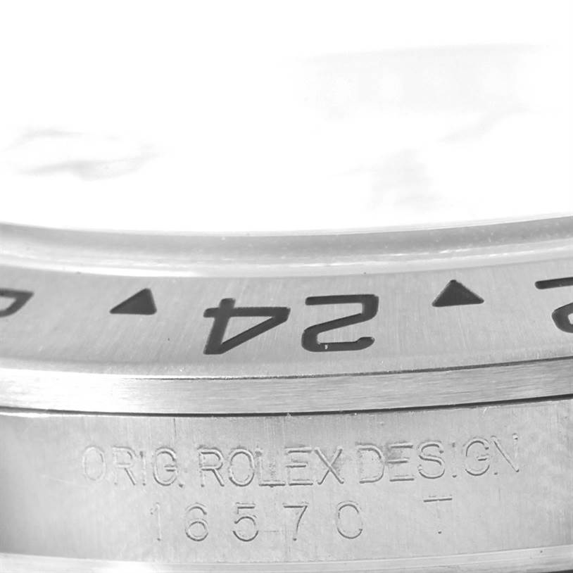 The image shows a close-up angle of the bezel and engraved model details of a Rolex Explorer 16570 Men's Stainless Steel White Dial 16570 Men's Stainless Steel White Dial watch.