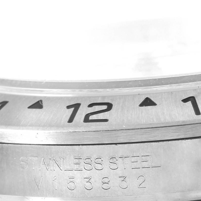 Close-up shot of the bezel and part of the case back of the Rolex Explorer 16570 Men's Stainless Steel White Dial 16570 Men's Stainless Steel White Dial, showing the 12-marker and steel engraving.