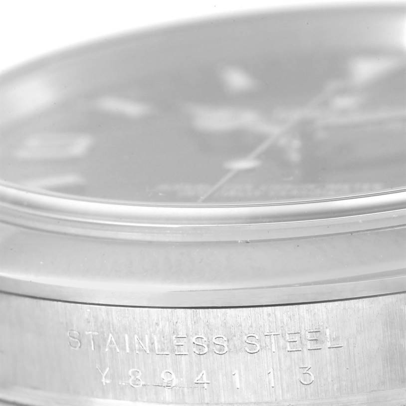 The image shows a close-up, side angle of the Rolex Explorer 114270 Men's Stainless Steel Black Dial 114270 Men's Stainless Steel Black Dial watch, highlighting the stainless steel case with engraved details.