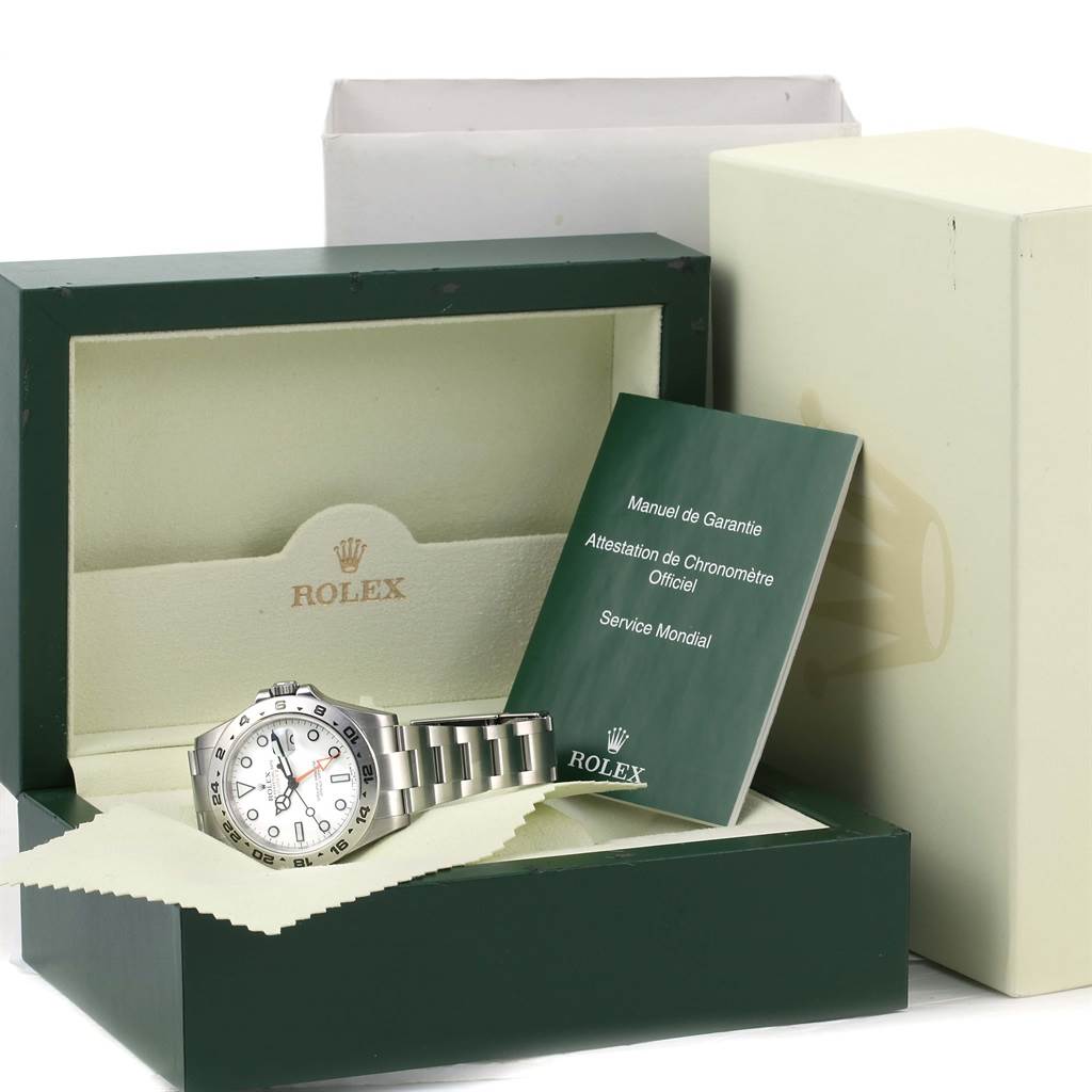 The image shows a Rolex Explorer 216570 Men's Stainless Steel White Dial 216570 Men's Stainless Steel White Dial watch placed in its box alongside warranty manuals.