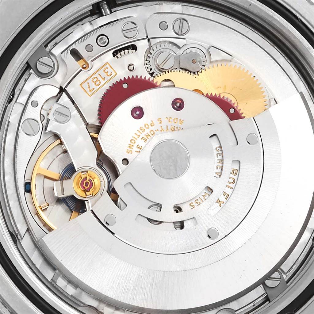The image shows a close-up of the movement and inner mechanics of a Rolex Explorer 216570 Men's Stainless Steel White Dial 216570 Men's Stainless Steel White Dial watch, highlighting the gears and rotor.