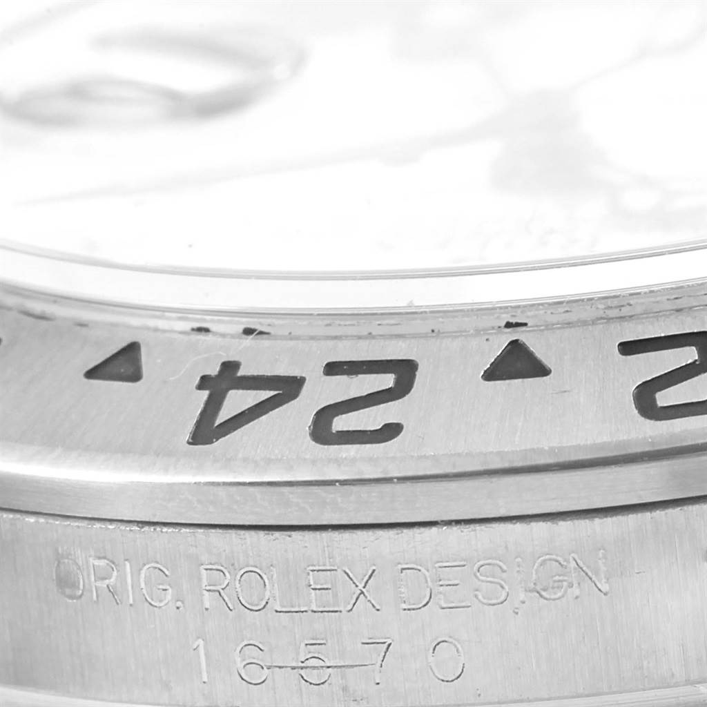 This close-up image shows the bezel and serial number engraving on the Rolex Explorer 16570 Men
s Stainless Steel White Dial 16570 Men
s Stainless Steel White Dial model.