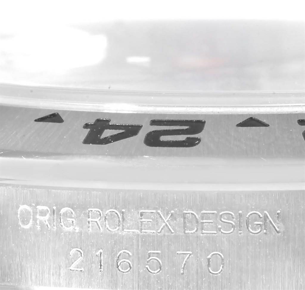 The image shows a close-up of the side case and bezel of a Rolex Explorer 216570 Men
s Stainless Steel White Dial 216570 Men
s Stainless Steel White Dial watch, featuring model number 216570.