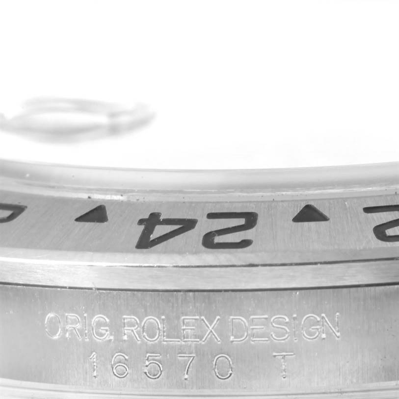 The image shows a close-up of the bezel and case side of a Rolex Explorer 16570 Men's Stainless Steel Black Dial 16570 Men's Stainless Steel Black Dial model, including engraved text and numerals.