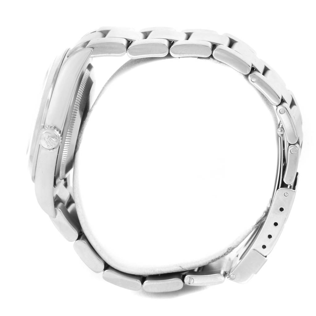 The Rolex Explorer 114270 Men's Stainless Steel Black Dial 114270 Men's Stainless Steel Black Dial watch is displayed from the side view, highlighting the case, crown, and metal bracelet.