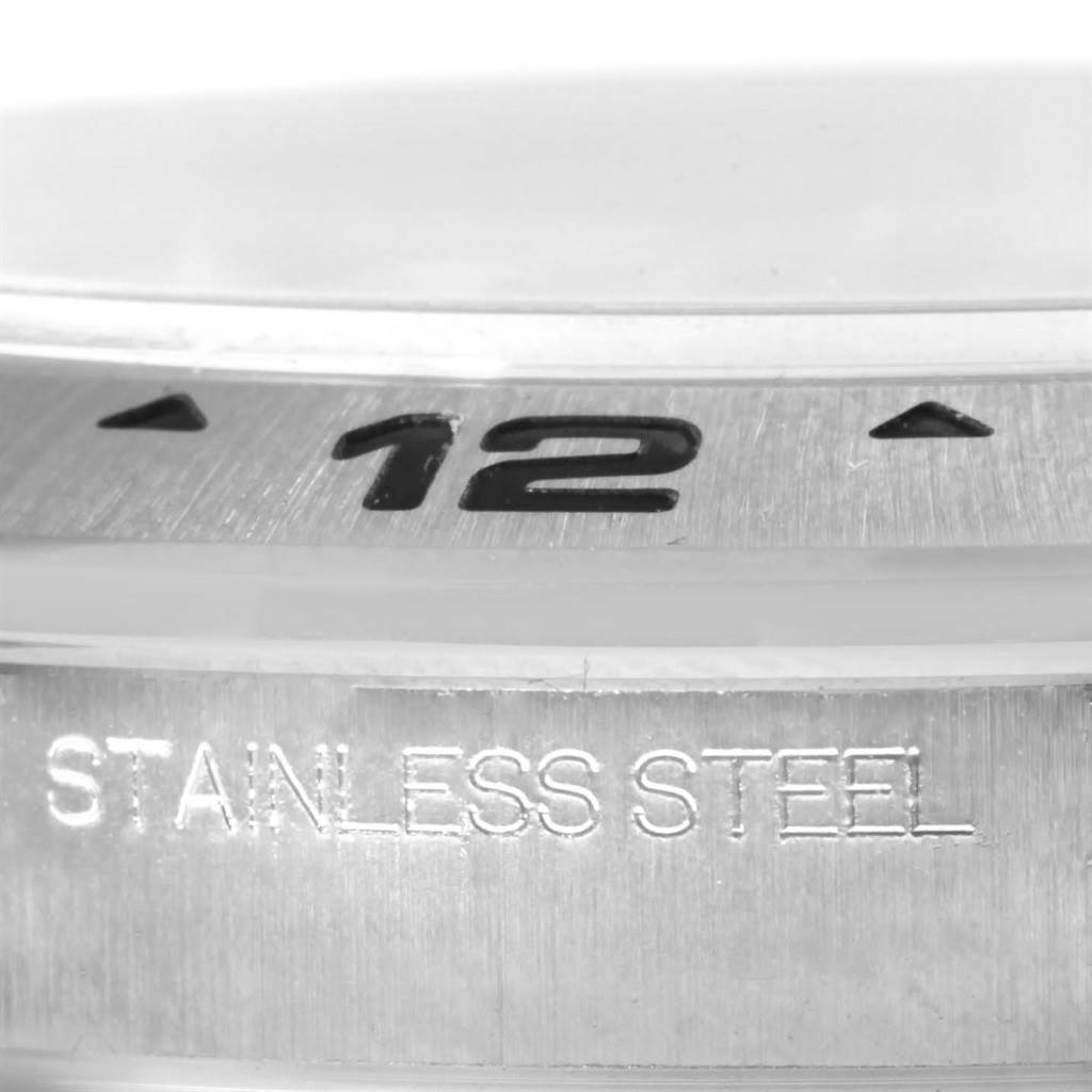 This image shows a close-up of the bezel and stainless steel marking on a Rolex Explorer 216570 Men
s Black Dial 216570 Men
s Black Dial watch.