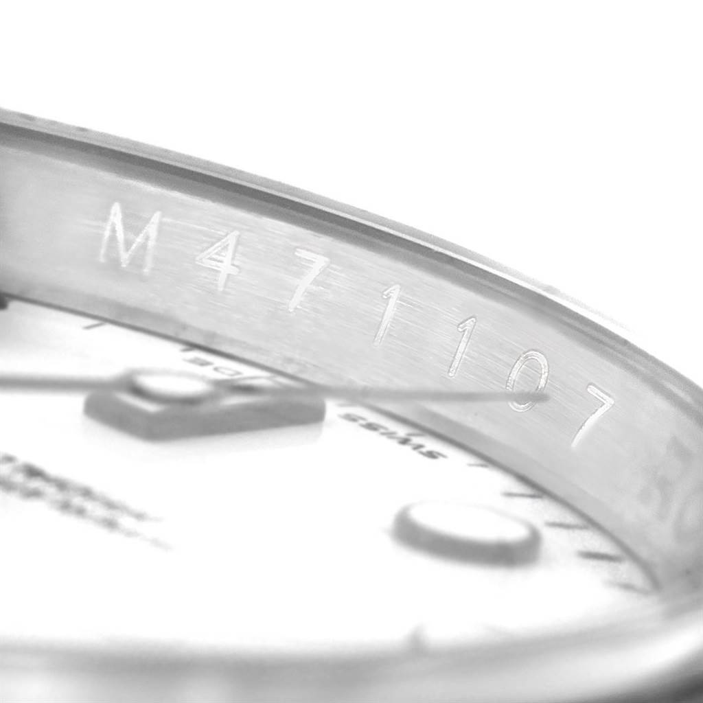 The image shows a close-up angle of the case and part of the dial of a Rolex Explorer 16570 Men's Stainless Steel White Dial 16570 Men's Stainless Steel White Dial watch, highlighting the serial number.