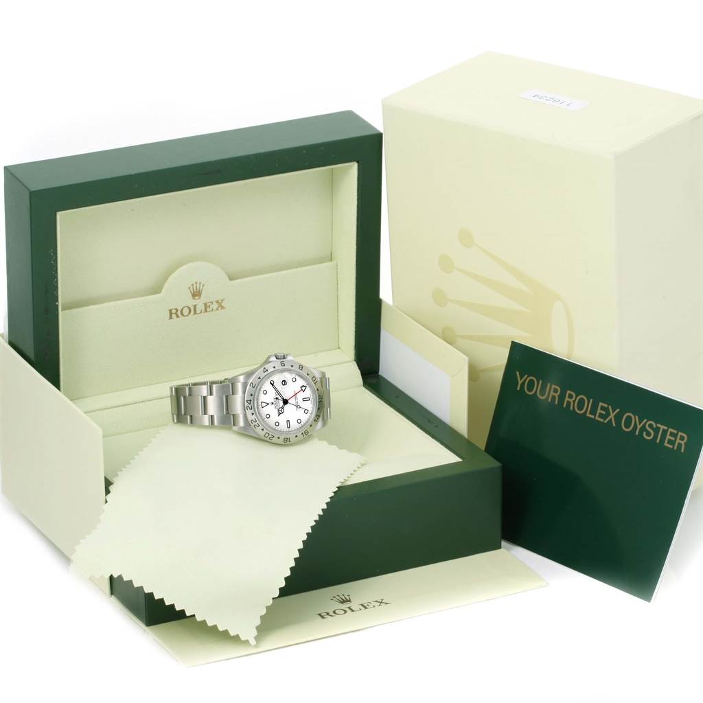 The image shows a Rolex Explorer 16570 Men's Stainless Steel White Dial 16570 Men's Stainless Steel White Dial watch inside its open box, alongside the outer box, warranty card, and cleaning cloth.