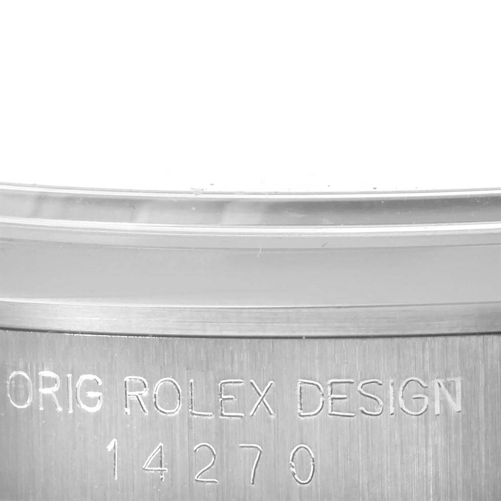 The image shows a close-up of the case back of a Rolex Explorer 14270 Men
s Stainless Steel Black Dial 14270 Men
s Stainless Steel Black Dial model, displaying the model number and "ORIG ROLEX DESIGN" engraving.