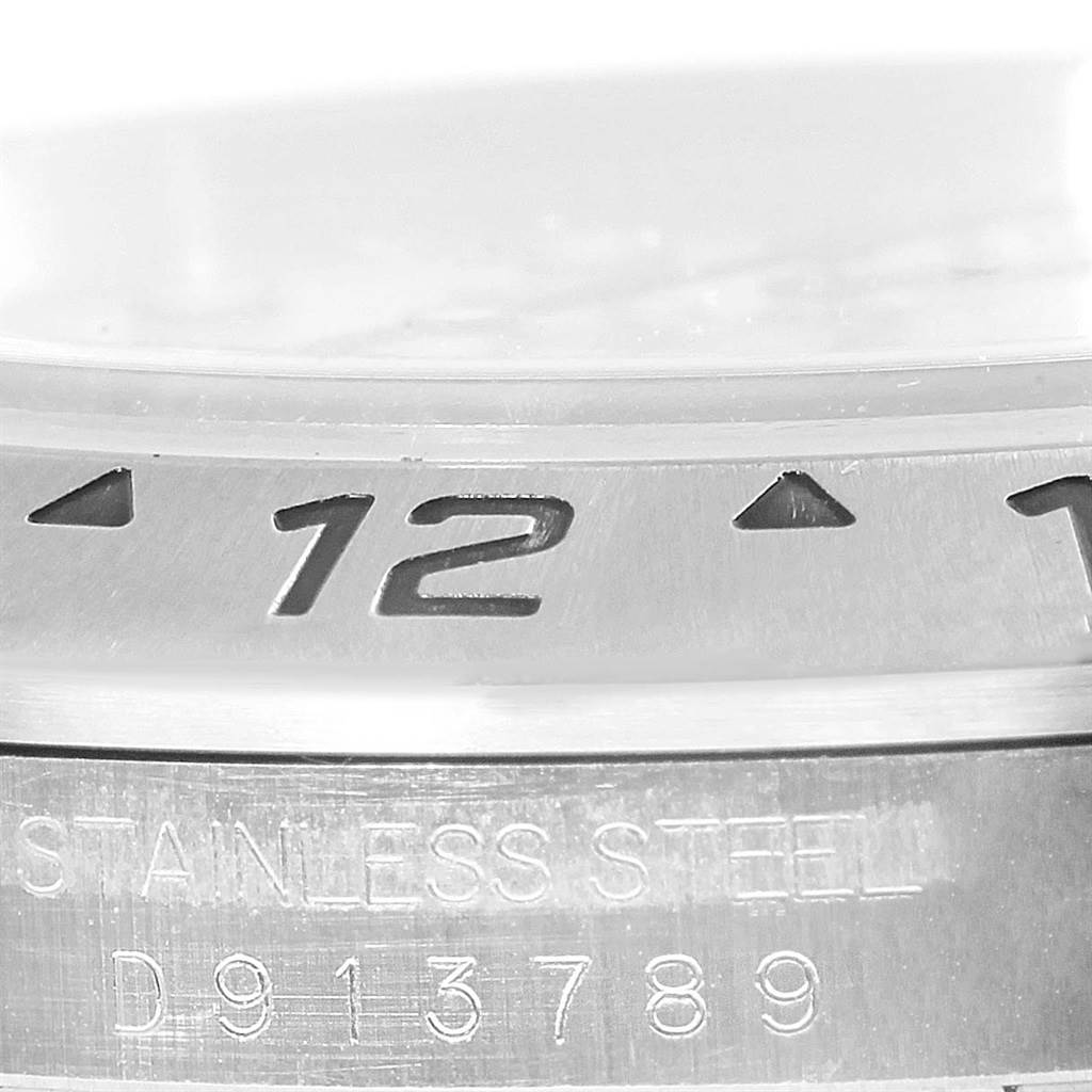 This close-up image shows the bezel and part of the case back with serial engraving on a Rolex Explorer 16570 Men's Stainless Steel White Dial 16570 Men's Stainless Steel White Dial model watch.