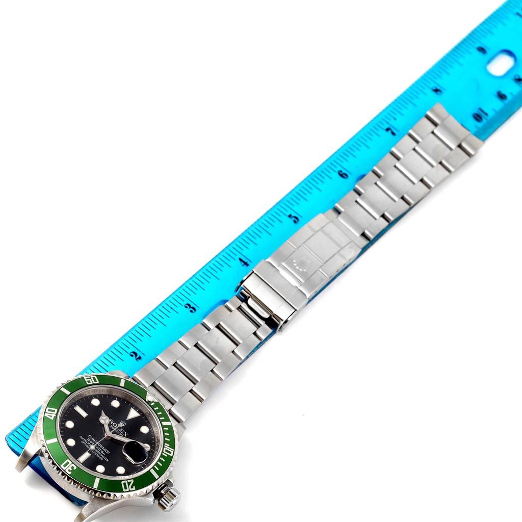 The image shows a Rolex Explorer 16610LV Men's Stainless Steel Black Dial 16610LV Men's Stainless Steel Black Dial watch laid flat next to a ruler, focusing on the bracelet and clasp.