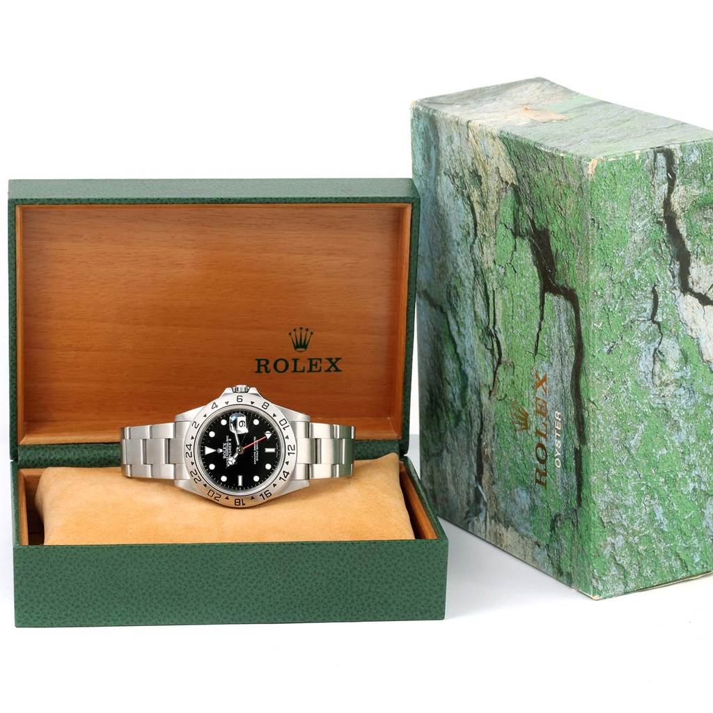 The image shows a Rolex Explorer 16570 Men's Stainless Steel Black Dial 16570 Men's Stainless Steel Black Dial model watch in its wooden box with an accompanying green outer box.