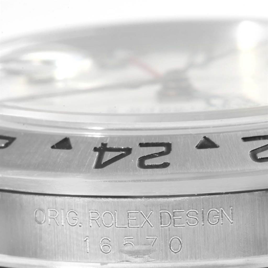 The image shows a close-up of the bezel and side of a Rolex Explorer 16570 Men's Stainless Steel White Dial 16570 Men's Stainless Steel White Dial watch, focusing on the engraved model number.