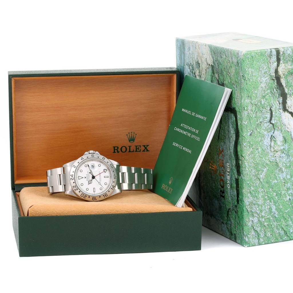 The image shows a Rolex Explorer 16570 Men's Stainless Steel White Dial 16570 Men's Stainless Steel White Dial watch displayed in its open box, along with accompanying manuals and packaging.