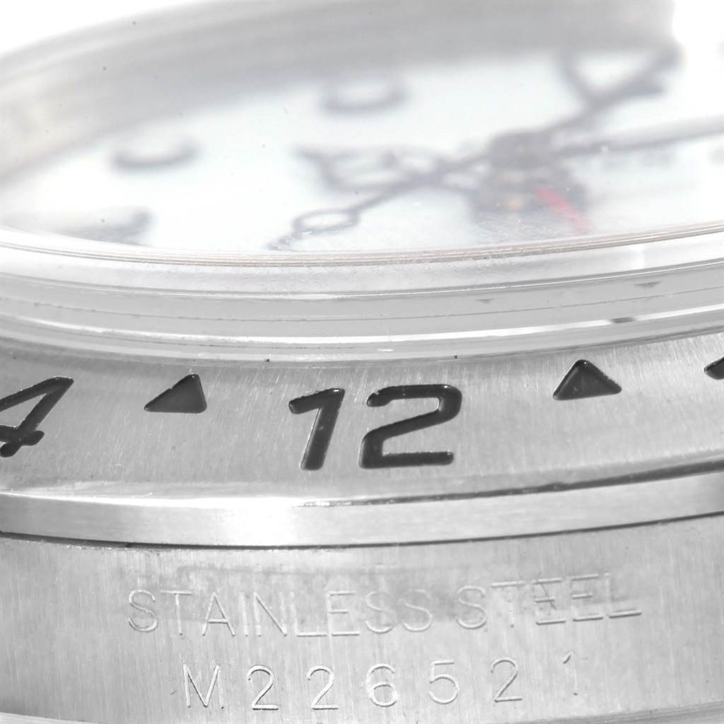 The image shows a close-up angle of the bezel, case, and crystal of a Rolex Explorer 16570 Men's Stainless Steel White Dial 16570 Men's Stainless Steel White Dial watch.