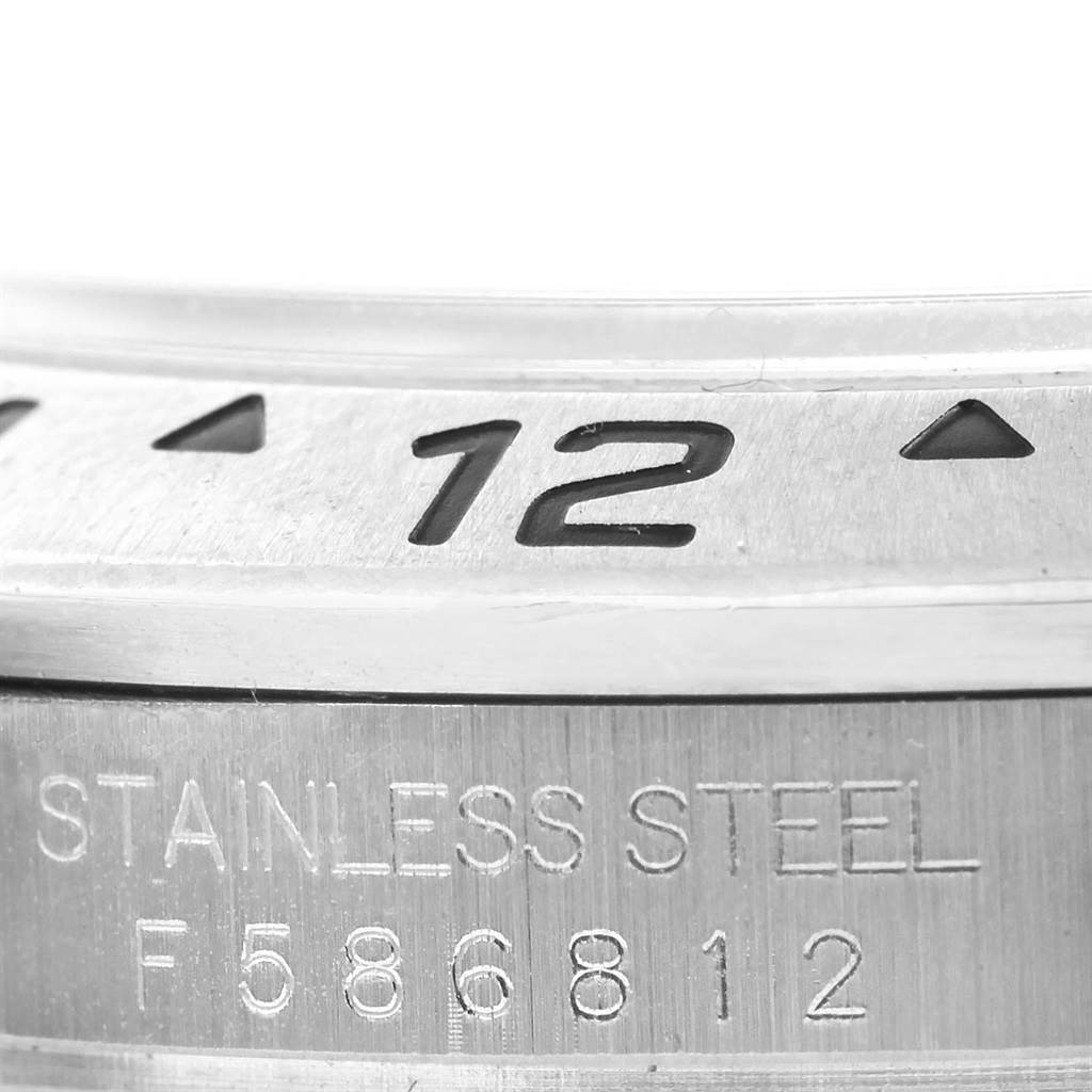 This image shows a close-up of the bezel, the "12" marker, and the engraved stainless steel text of a Rolex Explorer 16570 Men's Stainless Steel Black Dial 16570 Men's Stainless Steel Black Dial watch.