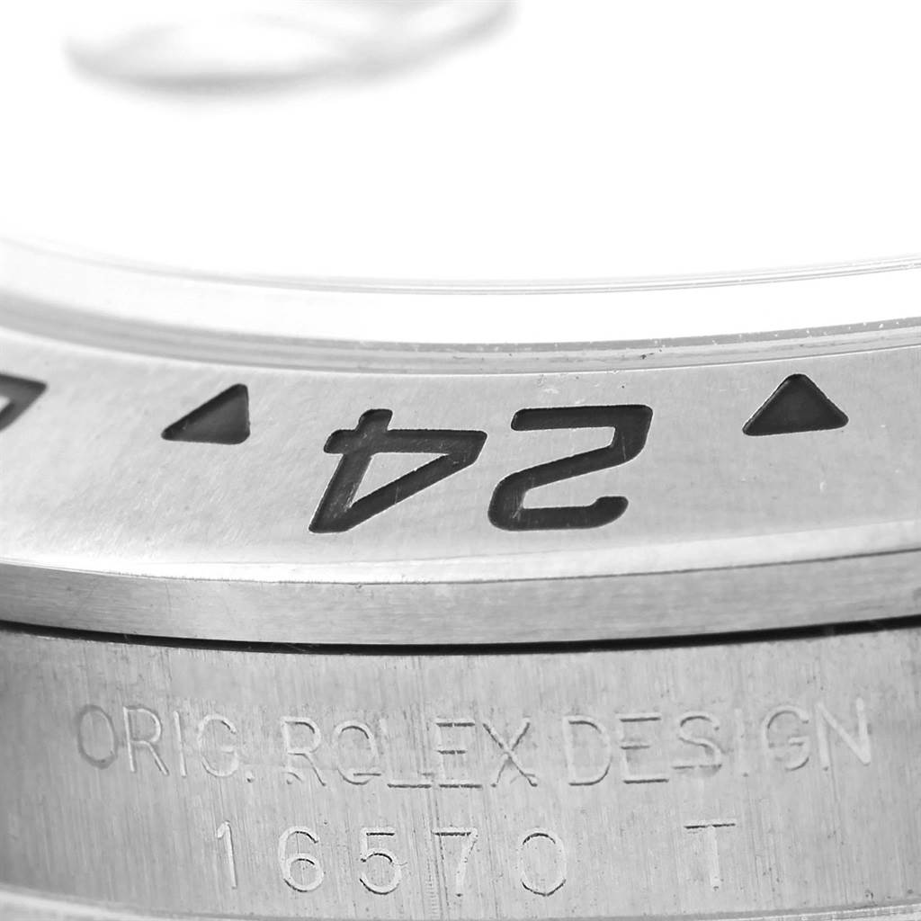 The close-up image shows the bezel of a Rolex Explorer 16570 Men's Stainless Steel Black Dial 16570 Men's Stainless Steel Black Dial watch, focusing on the 24-hour marker and engraved model information.