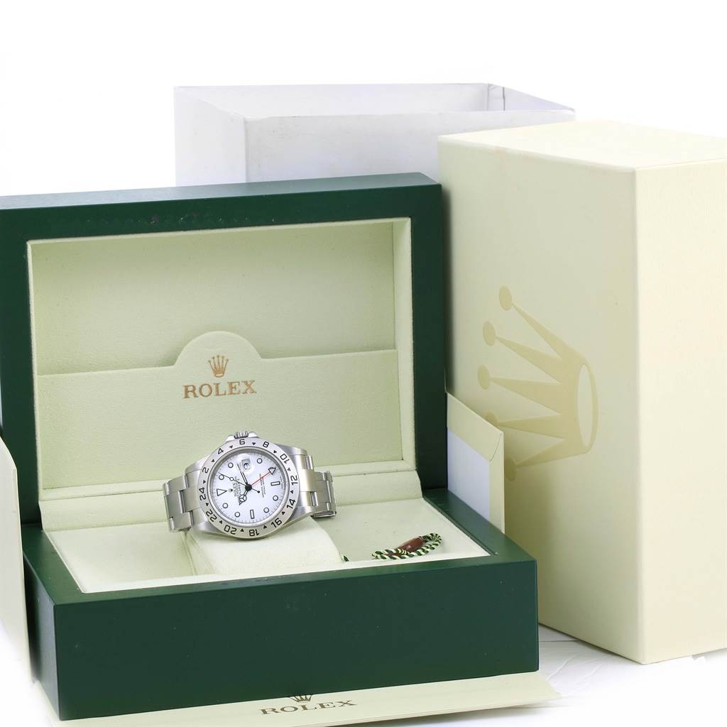 A Rolex Explorer 16570 Men's Stainless Steel White Dial 16570 Men's Stainless Steel White Dial watch is displayed in its open box with additional packaging in the background.