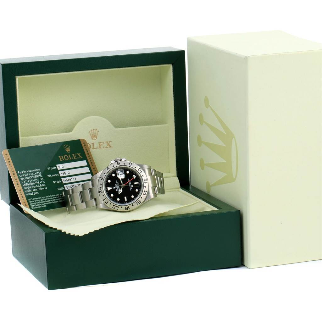 This image shows a Rolex Explorer 16570 Men's Stainless Steel Black Dial 16570 Men's Stainless Steel Black Dial watch in its opened box, along with a warranty card.