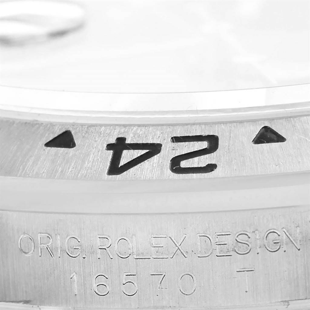 This close-up image shows the bezel and etched model number 16570T of a Rolex Explorer 16570 Men's Stainless Steel Black Dial 16570 Men's Stainless Steel Black Dial watch.
