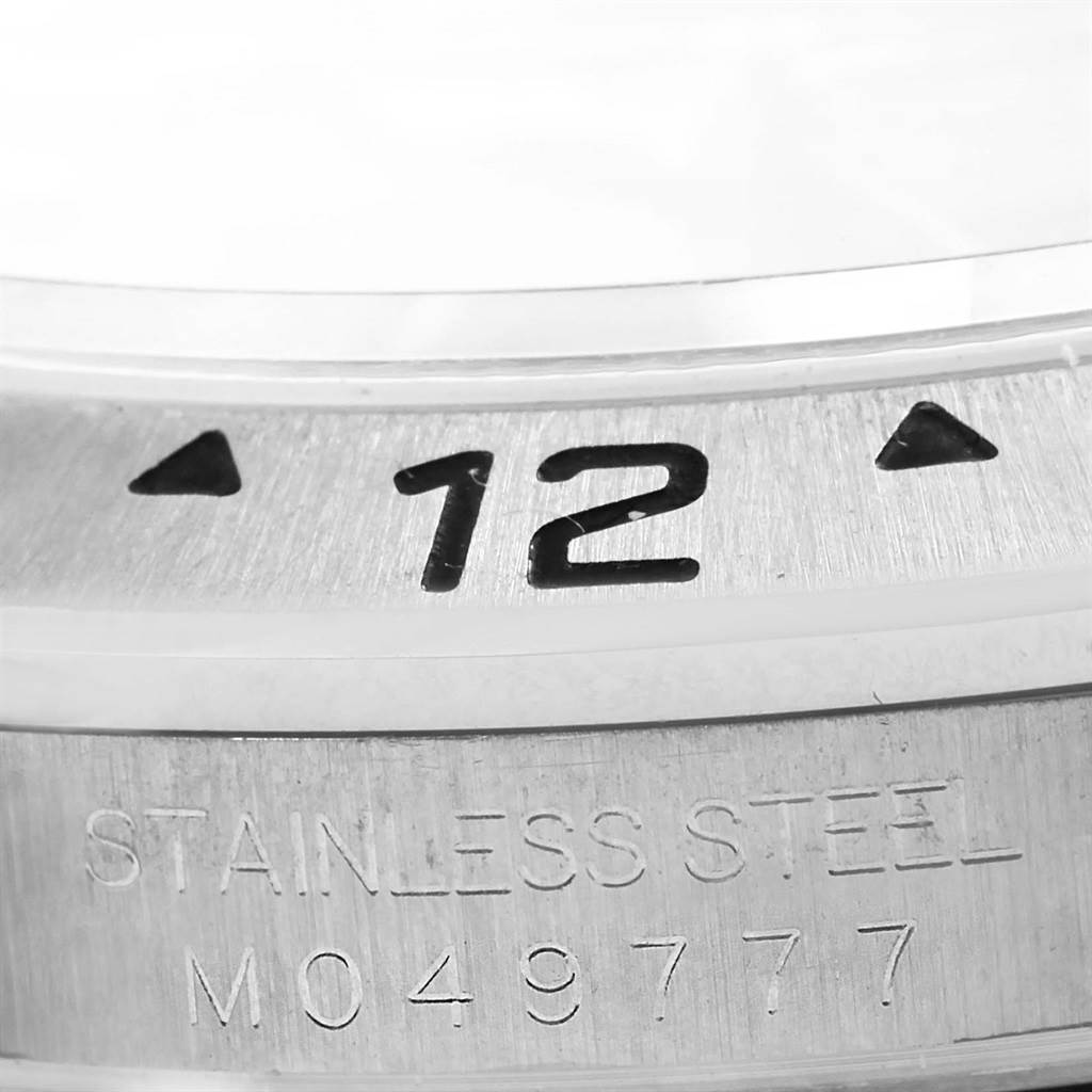 This close-up image shows the bezel and stainless steel case with model and serial numbers of a Rolex Explorer 16570 Men's Stainless Steel Black Dial 16570 Men's Stainless Steel Black Dial watch.