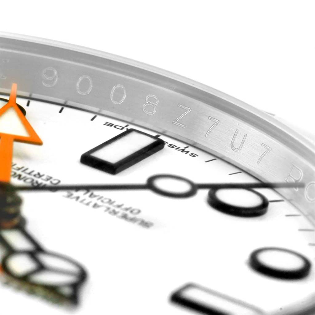 This close-up image shows the dial and part of the bezel with engraved numbers of the Rolex Explorer 216570 Men's Stainless Steel White Dial 216570 Men's Stainless Steel White Dial watch.