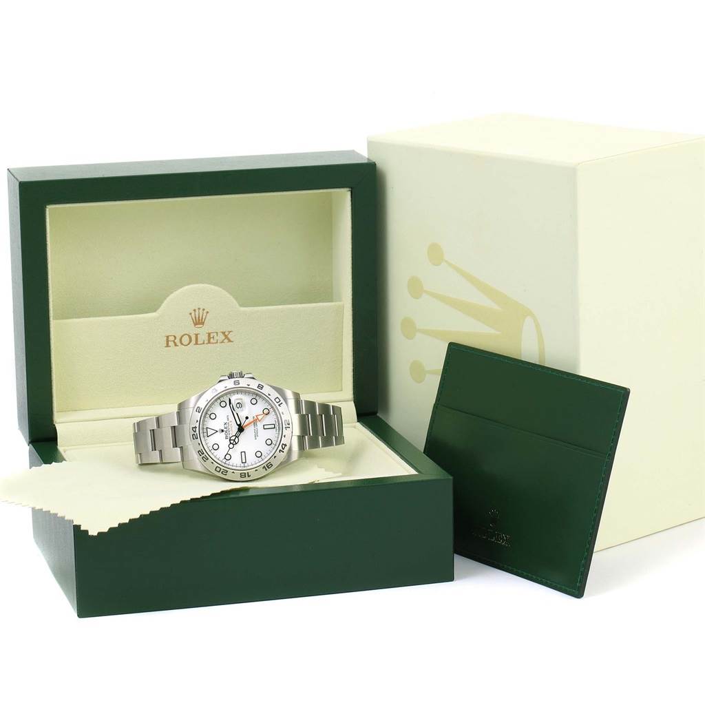 The Rolex Explorer 216570 Men's Stainless Steel White Dial 216570 Men's Stainless Steel White Dial watch is displayed inside its branded box, with an outer box and documentation holder visible beside it.