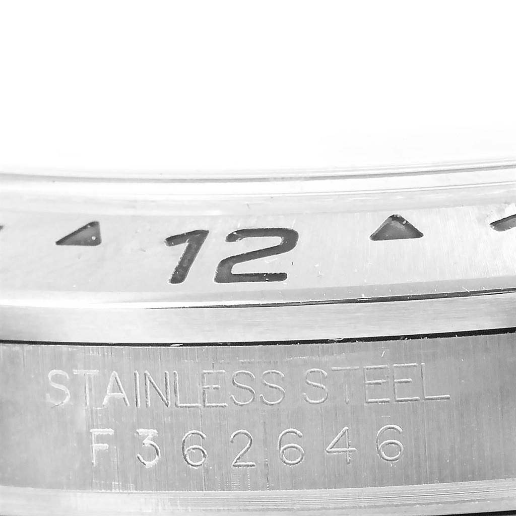 This image displays a close-up of the bezel and the engraved serial number of a Rolex Explorer 16570 Men's Stainless Steel Black Dial 16570 Men's Stainless Steel Black Dial watch.