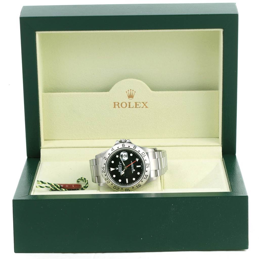 The image shows a front view of a Rolex Explorer 16570 Men's Stainless Steel Black Dial 16570 Men's Stainless Steel Black Dial watch inside its green and cream presentation box.