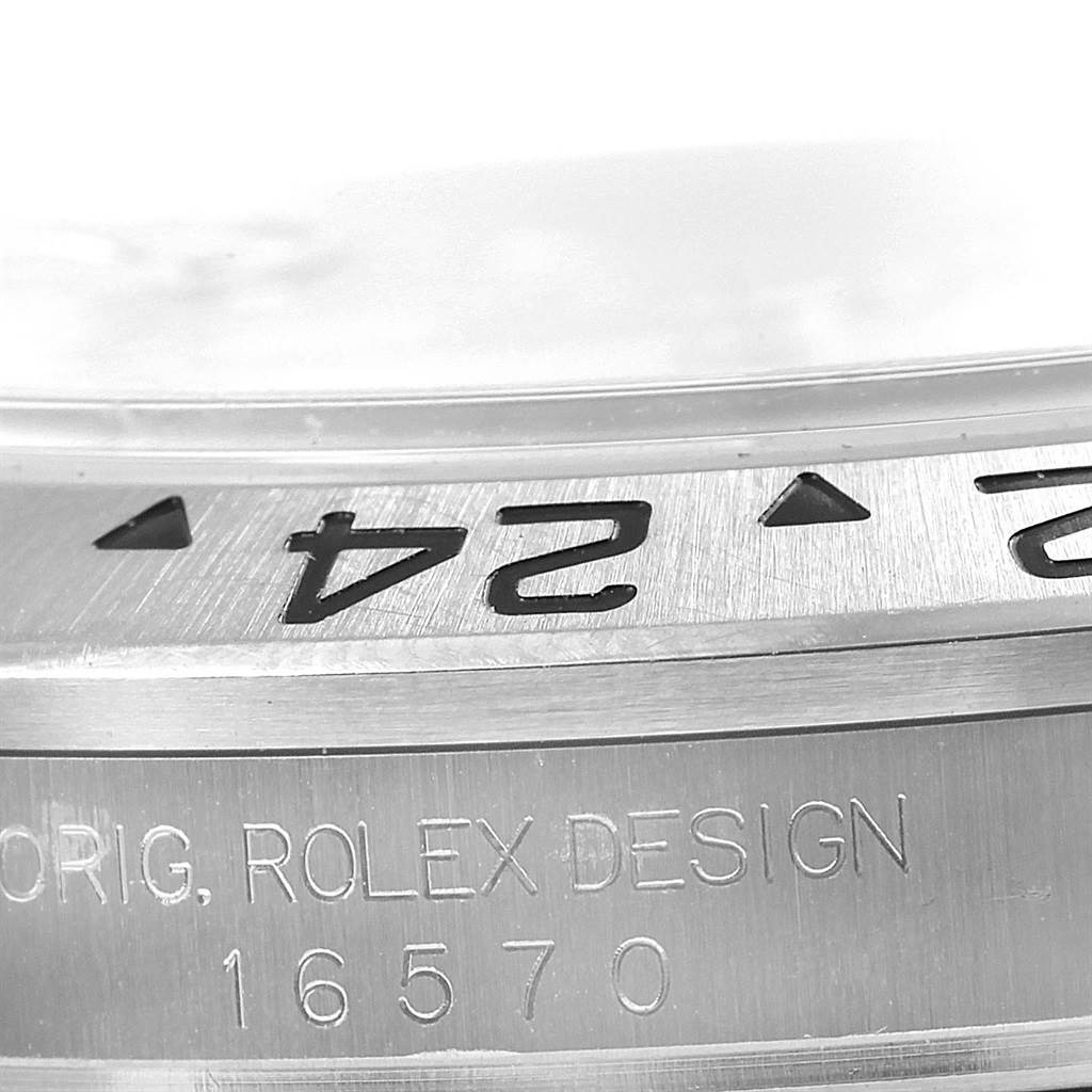 This close-up image of the Rolex Explorer 16570 Men's Stainless Steel White Dial 16570 Men's Stainless Steel White Dial shows a partial view of the bezel and the engraved model number 16570 on the case.