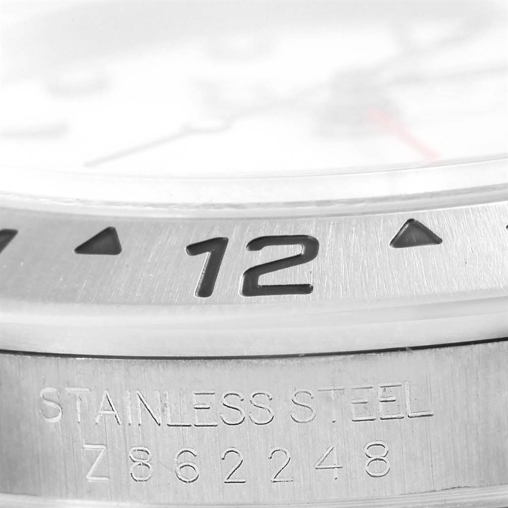 This image shows a close-up angle of the bezel and stainless steel engraving of a Rolex Explorer 16570 Men's Stainless Steel White Dial 16570 Men's Stainless Steel White Dial watch, highlighting the 12 marker.