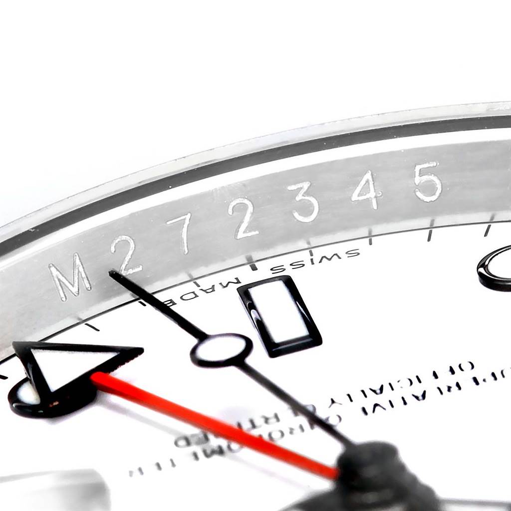 This close-up of a Rolex Explorer 16570 Men's Stainless Steel White Dial 16570 Men's Stainless Steel White Dial watch shows part of the bezel, dial, and hands, including the serial number engraved on the inner bezel.