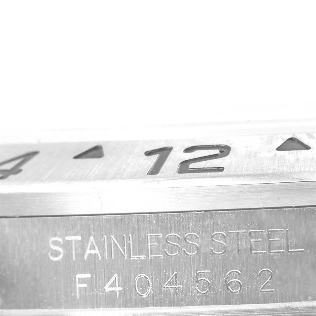 The image shows a close-up of the bezel and inscription on the side of a Rolex Explorer 16570 Men
s Stainless Steel White Dial 16570 Men
s Stainless Steel White Dial model watch.