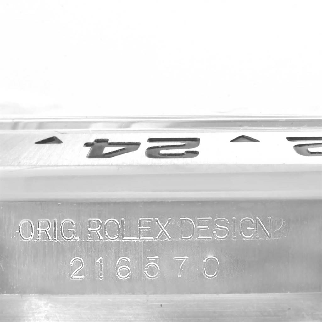 This image shows a close-up of the bezel and the engraved serial number on a Rolex Explorer 216570 Men's Stainless Steel Black Dial 216570 Men's Stainless Steel Black Dial model.