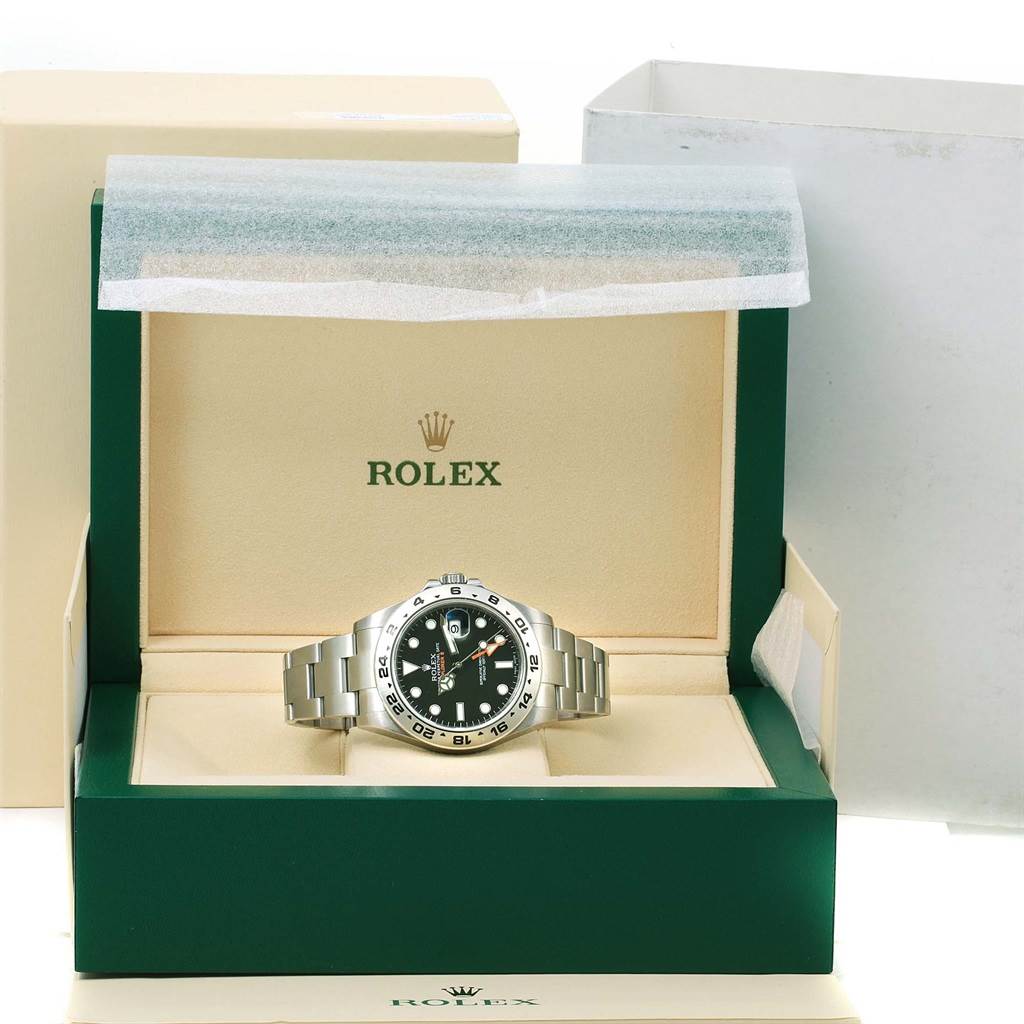 The Rolex Explorer 216570 Men's Stainless Steel Black Dial 216570 Men's Stainless Steel Black Dial watch is displayed front-on in an open green box with its surrounding packaging visible.