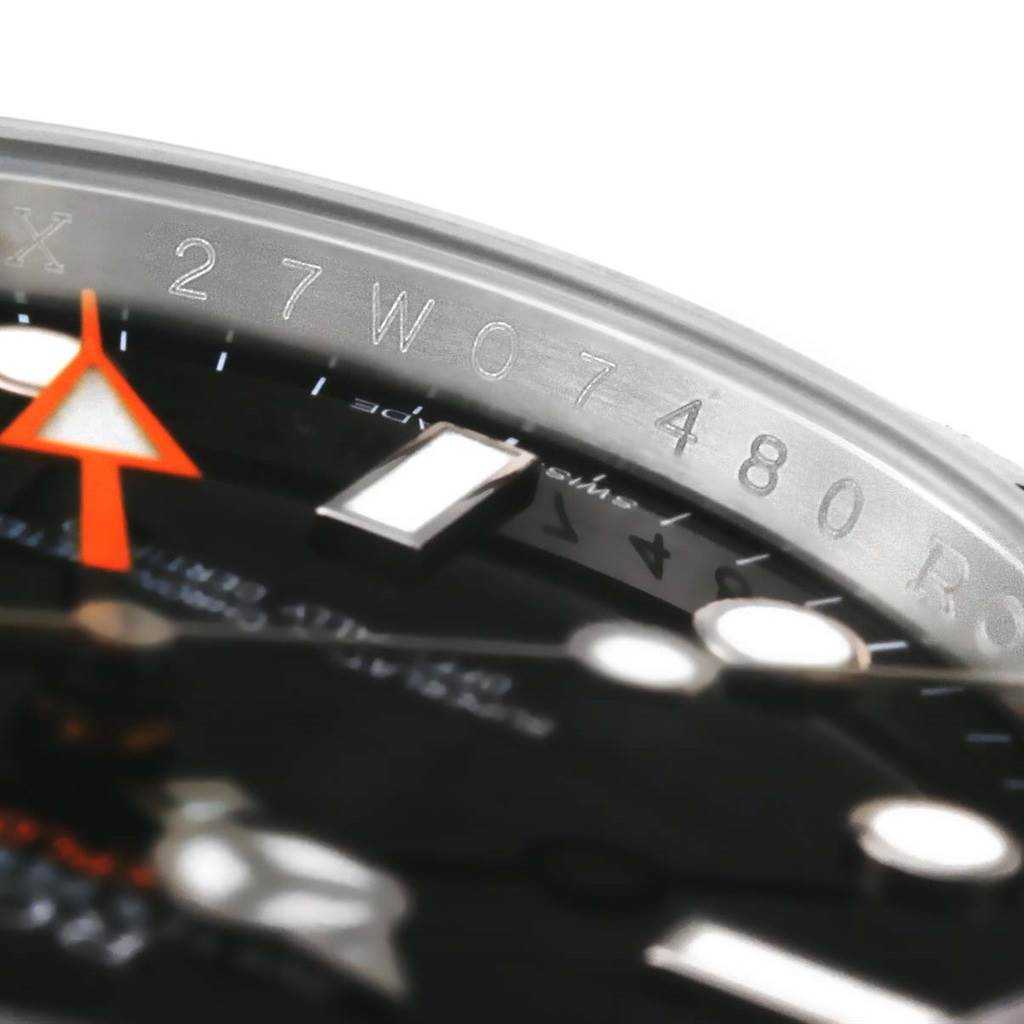 This close-up image shows the dial and serial number on the bezel of a Rolex Explorer 216570 Men's Stainless Steel Black Dial 216570 Men's Stainless Steel Black Dial watch.