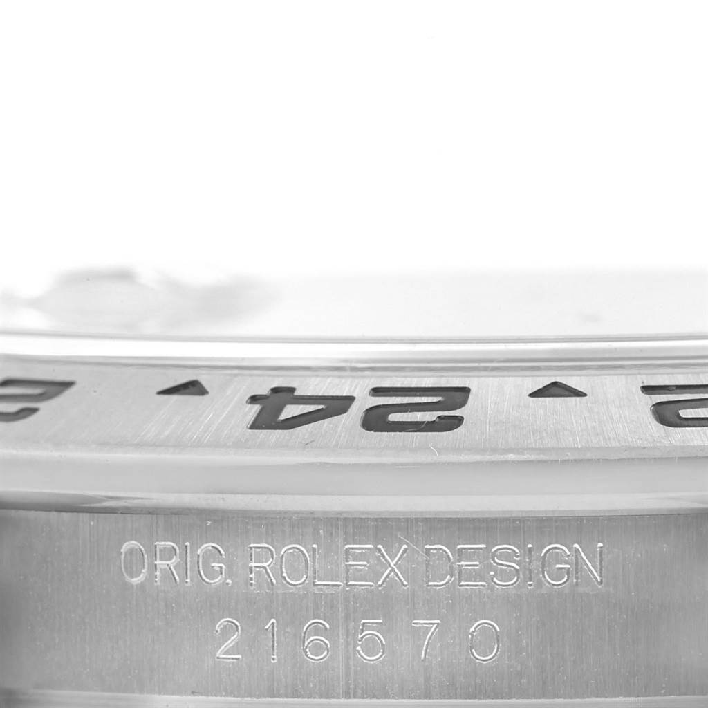 This image shows a close-up of the bezel and engraving on the side of a Rolex Explorer 216570 Men's Stainless Steel White Dial 216570 Men's Stainless Steel White Dial watch.