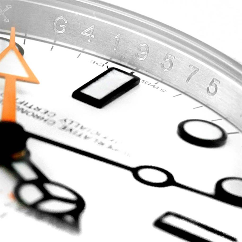 This close-up of the Rolex Explorer 216570 Men's Stainless Steel White Dial 216570 Men's Stainless Steel White Dial watch shows its hands, dial, and an engraved number on the inner bezel ring.