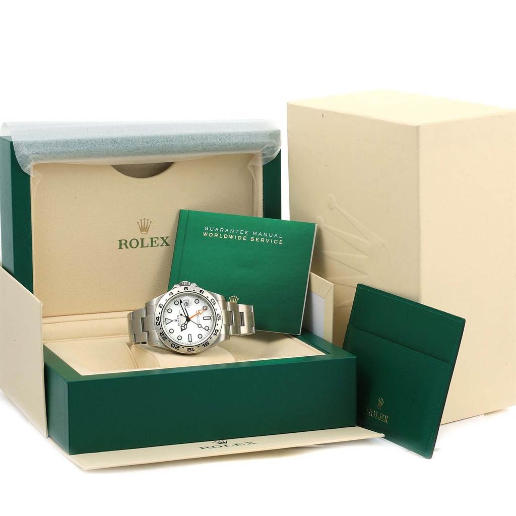 The image shows a Rolex Explorer 216570 Men's Stainless Steel White Dial 216570 Men's Stainless Steel White Dial watch inside its box along with warranty booklets and packaging materials.
