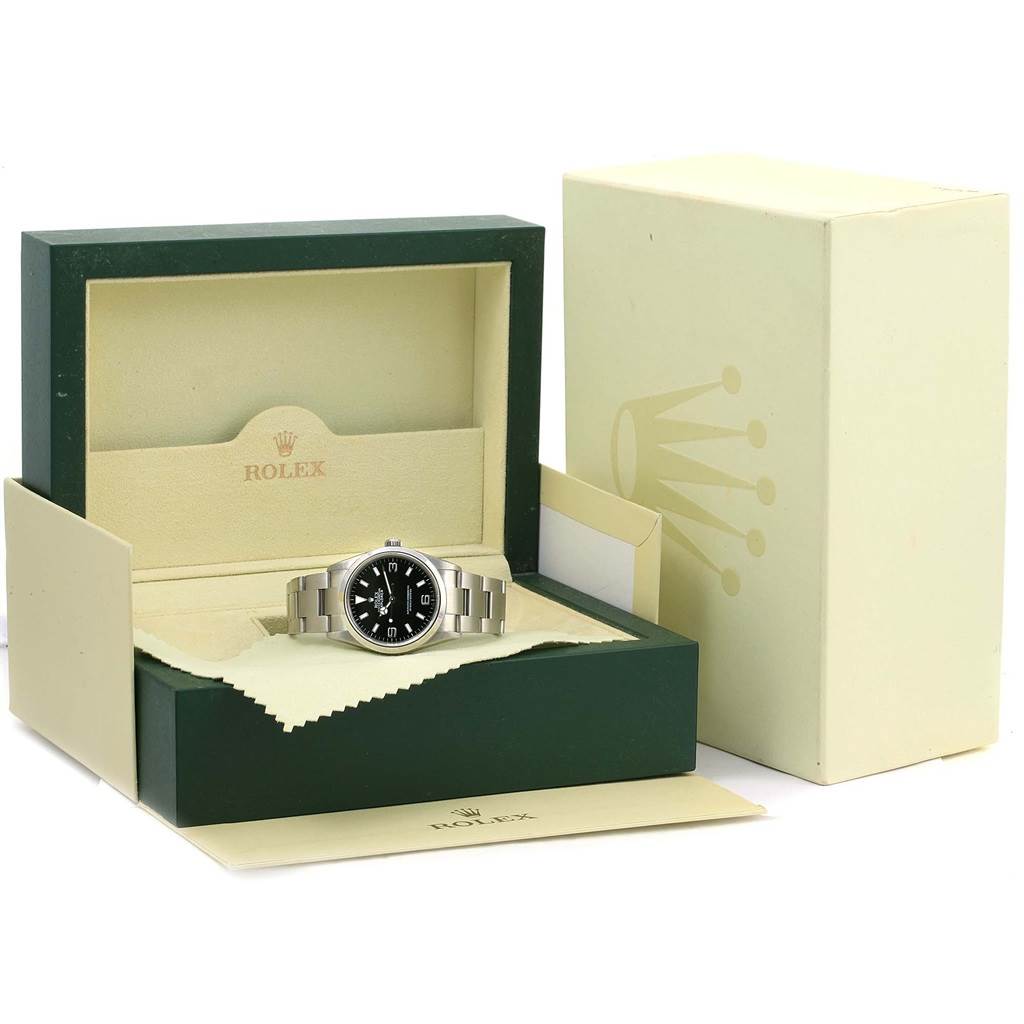 The Rolex Explorer 114270 Men's Stainless Steel Black Dial 114270 Men's Stainless Steel Black Dial watch is shown inside its open box, positioned slightly from the front.