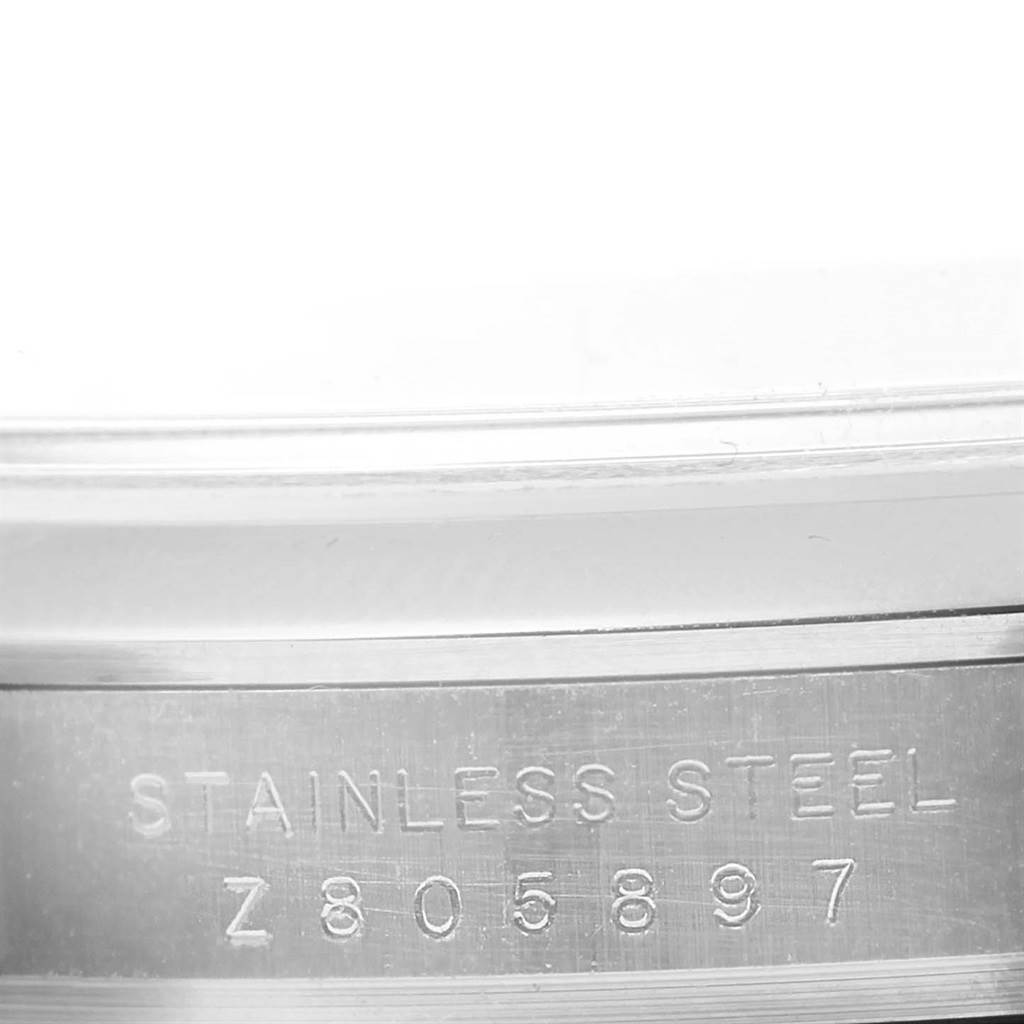 This image shows the serial number and "stainless steel" engraving on the case back edge of a Rolex Explorer 114270 Men's Stainless Steel Black Dial 114270 Men's Stainless Steel Black Dial watch.