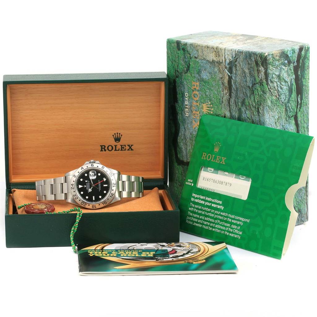 The image shows a Rolex Explorer 16570 Men's Stainless Steel Black Dial 16570 Men's Stainless Steel Black Dial watch, its box, warranty card, and booklet, all oriented for a frontal view.