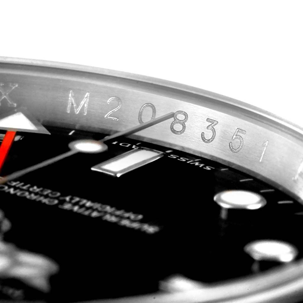 This close-up image of the Rolex Explorer 16570 Men's Stainless Steel Black Dial 16570 Men's Stainless Steel Black Dial watch shows part of the dial and the rehaut engraving.