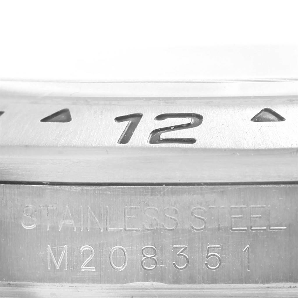 This image shows a close-up of the bezel and case engravings of a Rolex Explorer 16570 Men's Stainless Steel Black Dial 16570 Men's Stainless Steel Black Dial, highlighting the "12" marker and stainless steel text.
