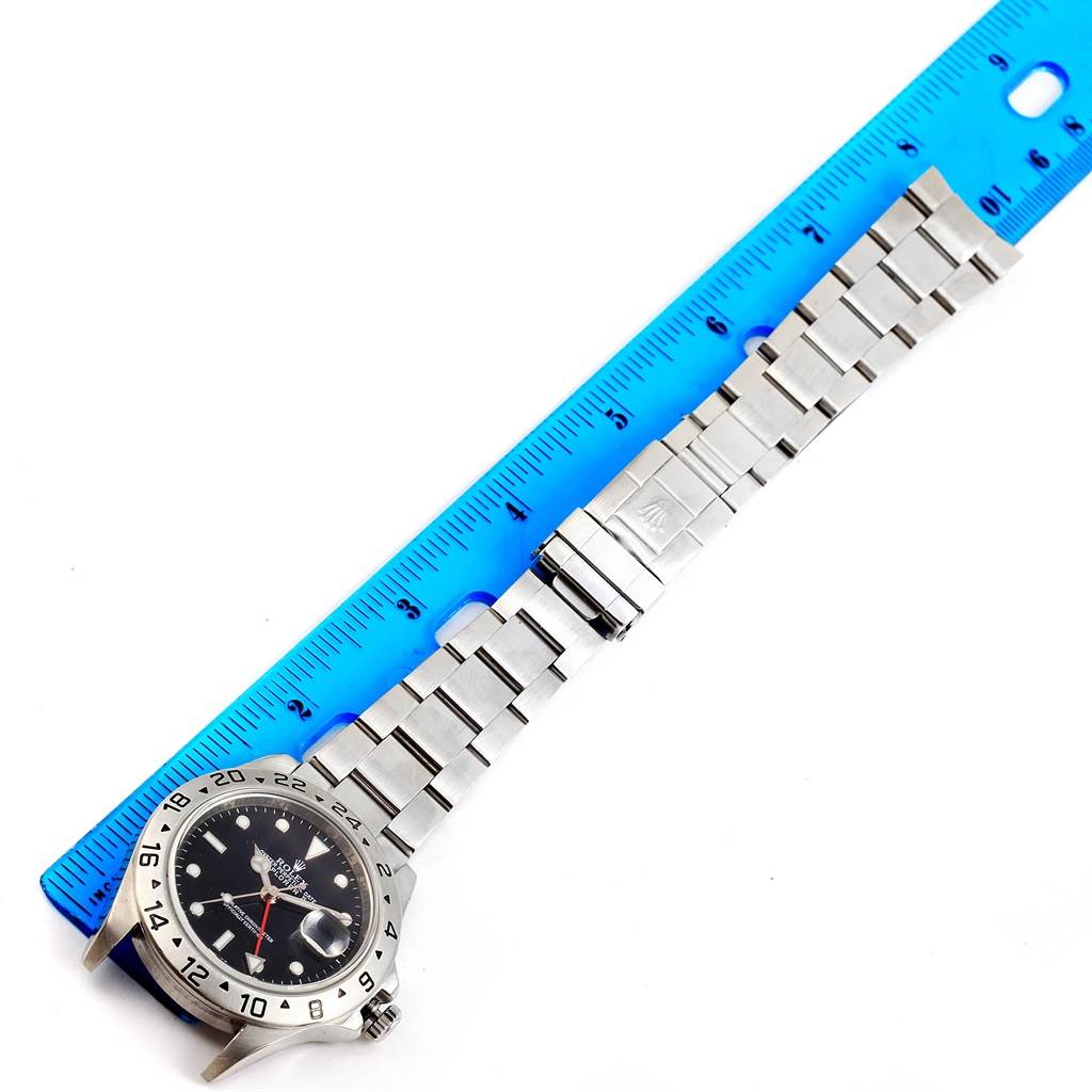 The image shows a Rolex Explorer 16570 Men's Stainless Steel Black Dial 16570 Men's Stainless Steel Black Dial watch laid flat, measured against a blue ruler, displaying the bezel, dial, and bracelet.