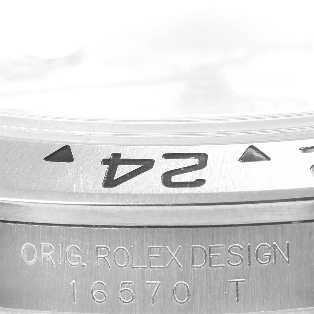 This image shows a close-up angle of the bezel and case of the Rolex Explorer 16570 Men's Stainless Steel White Dial 16570 Men's Stainless Steel White Dial model, highlighting the engraved numbers and design.
