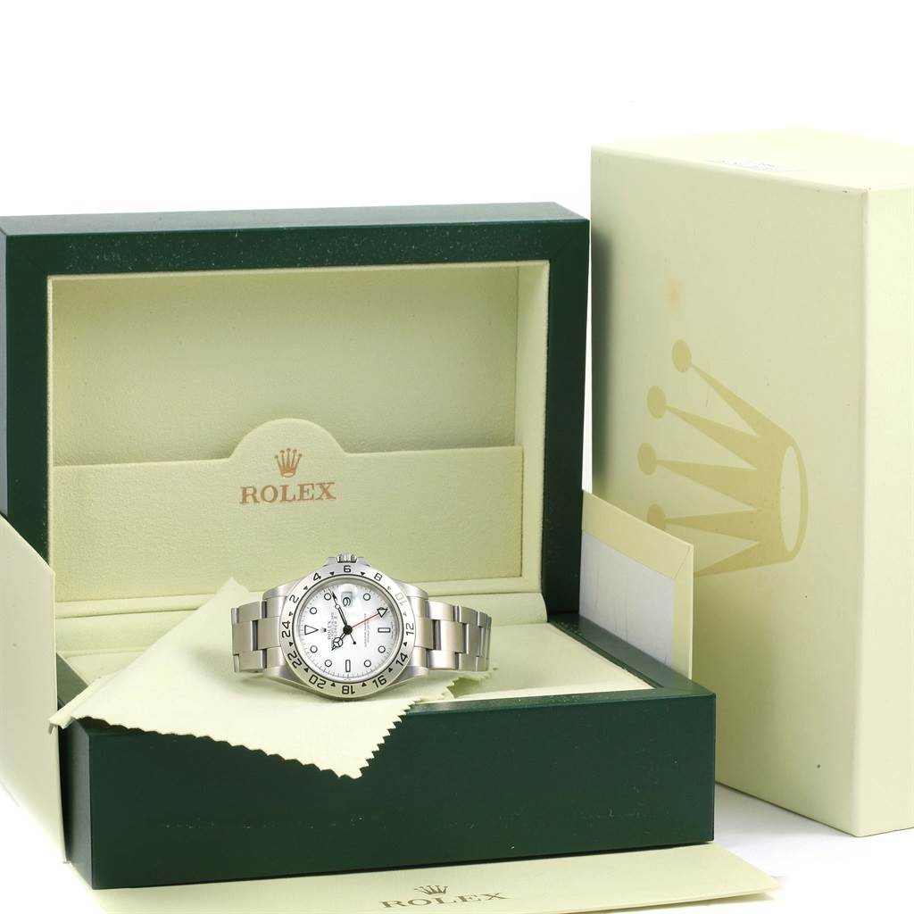 The image shows a Rolex Explorer 16570 Men's Stainless Steel White Dial 16570 Men's Stainless Steel White Dial watch placed in an open green and beige Rolex box with additional packaging visible.