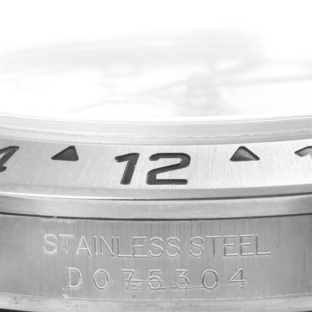 This close-up image shows the bezel and part of the case with engravings for the Rolex Explorer 16570 Men's Stainless Steel White Dial 16570 Men's Stainless Steel White Dial watch.